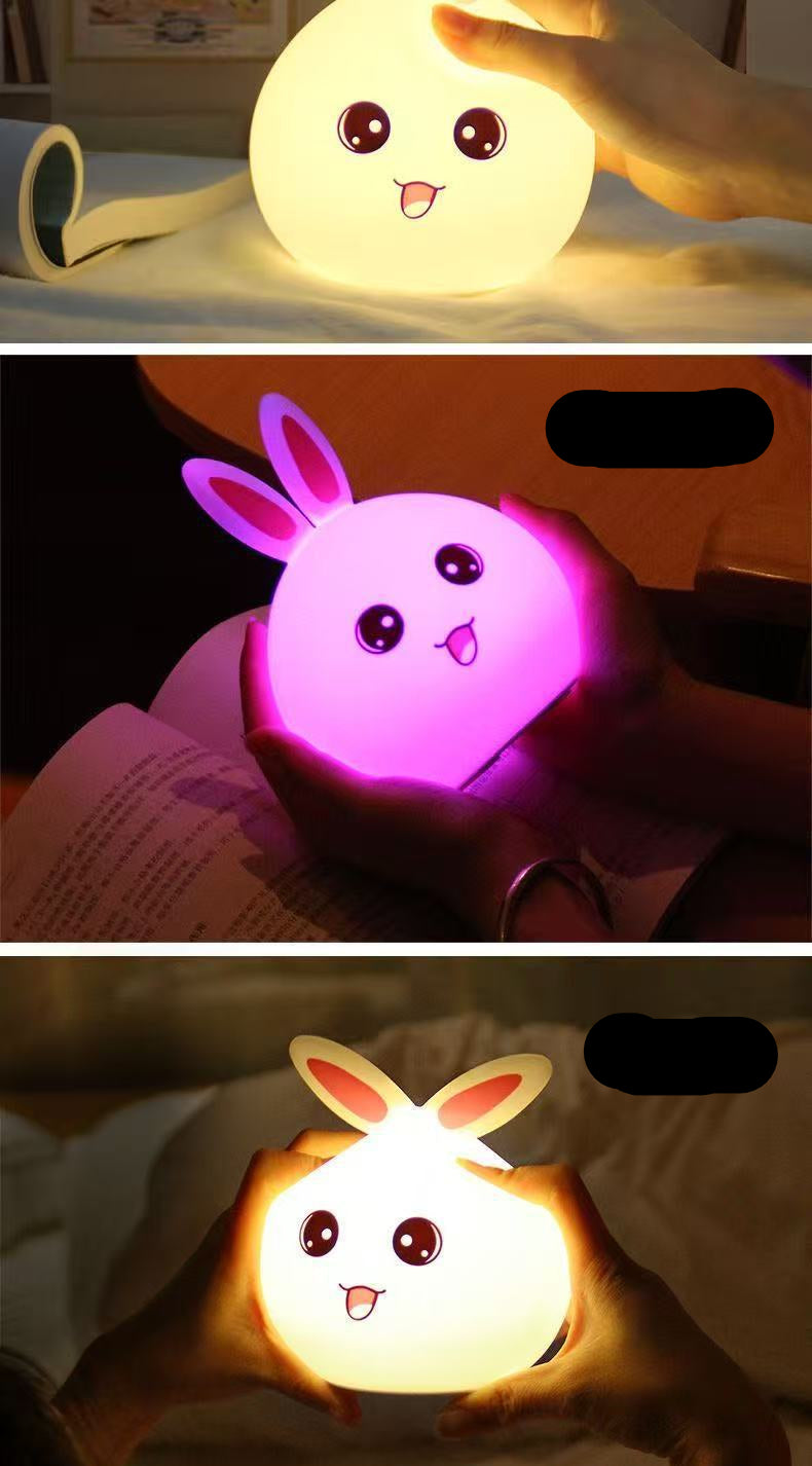 Three different night lights shaped like a moon, rabbit, and bunny held by people.
